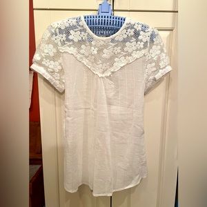 Cute top, buttons on sleeves and back of neck. Dressy or casual